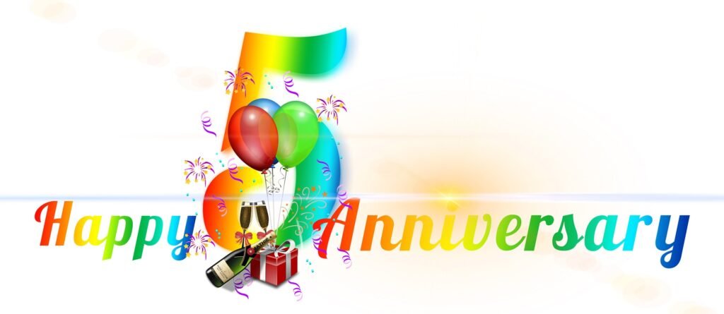 Happy 5th anniversary celebration with balloons gifts and champagne