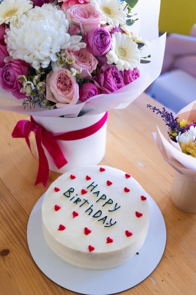 Cute pastel birthday cake with Happy Birthday message and candles